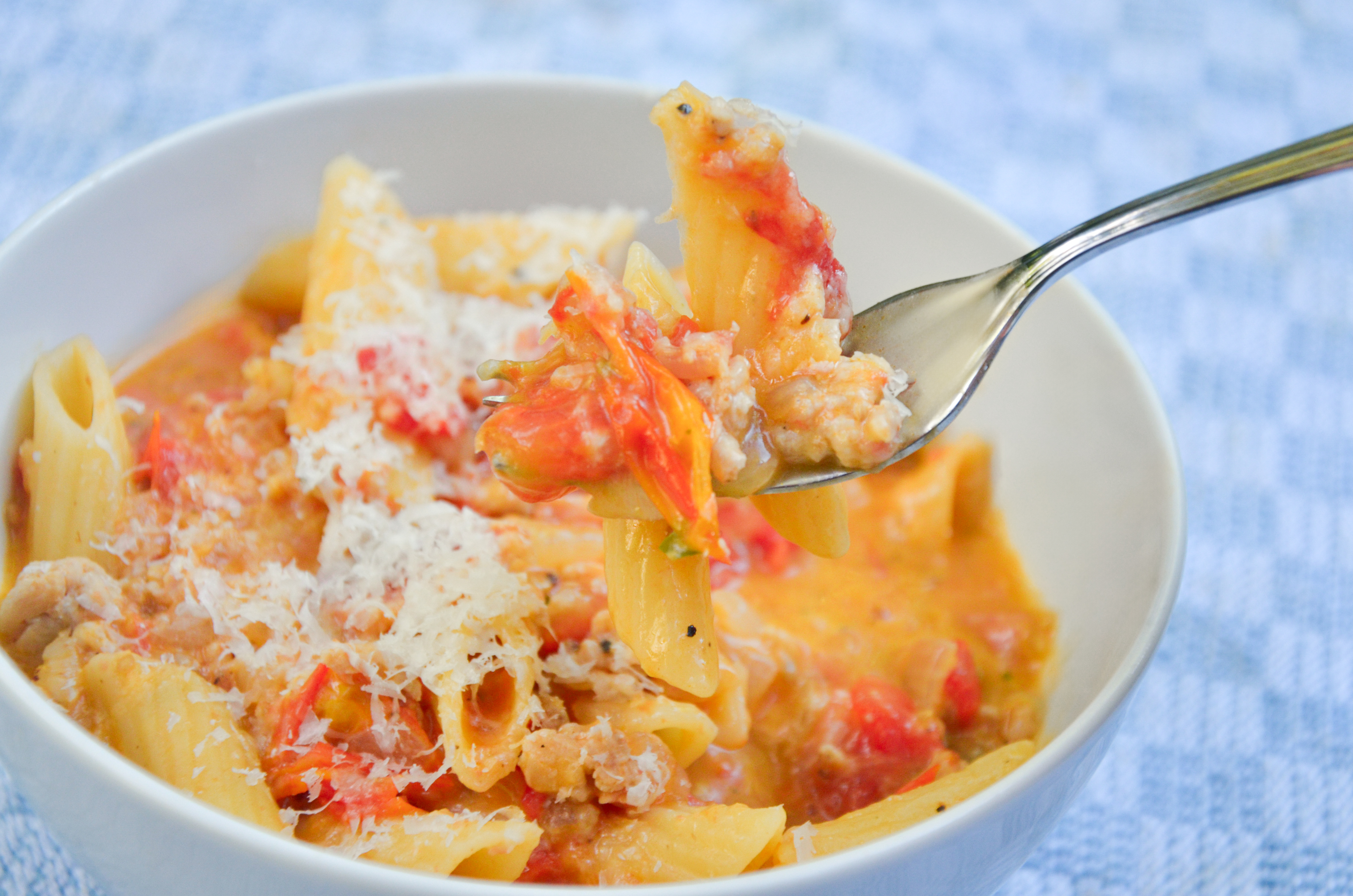 Creamy Boursin pasta with ground chicken and cherry tomatoes in a Dutch oven.